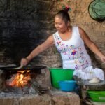 woman in white and pink floral tank top cooking